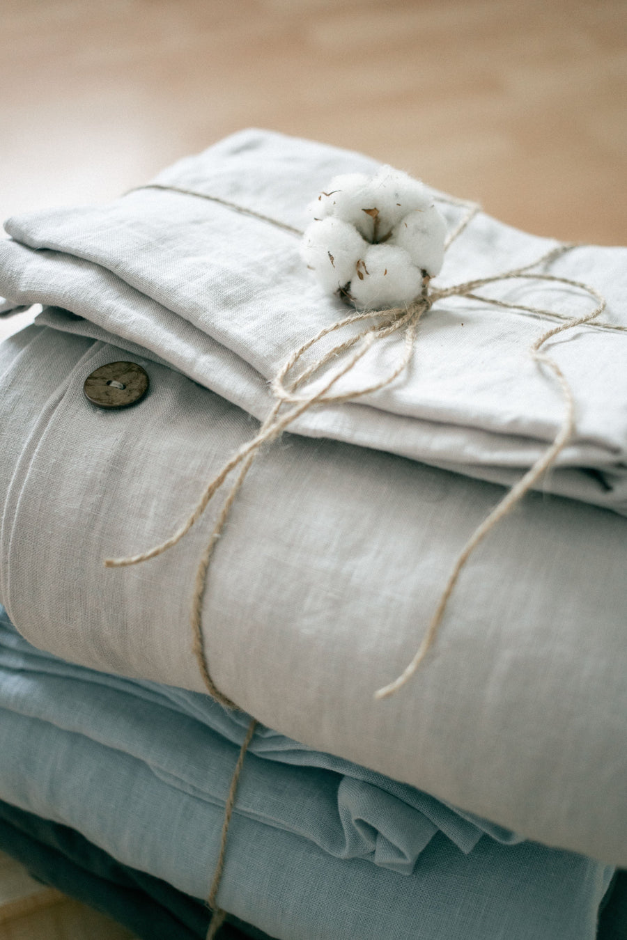 Soft folded linens and cotton stems