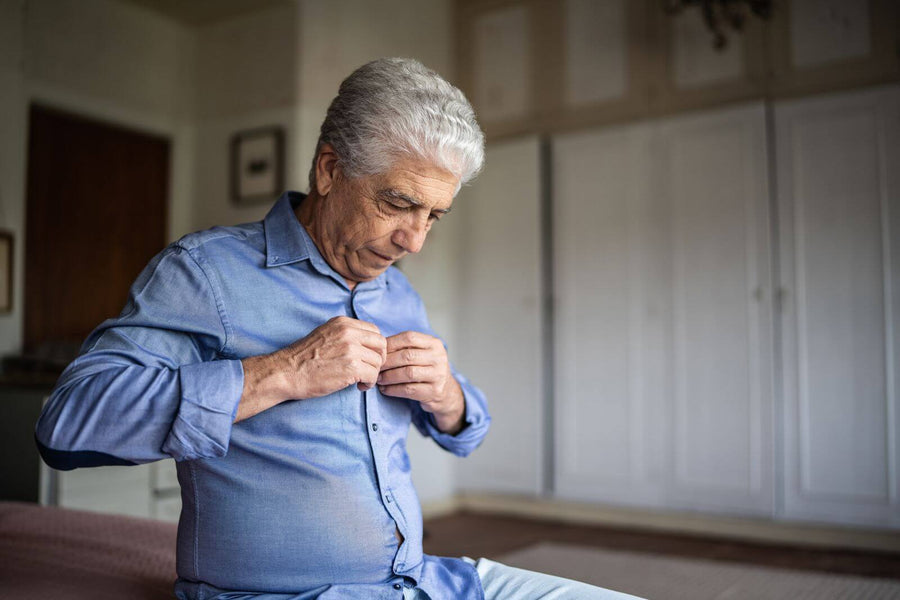 Older man getting dressed confidently