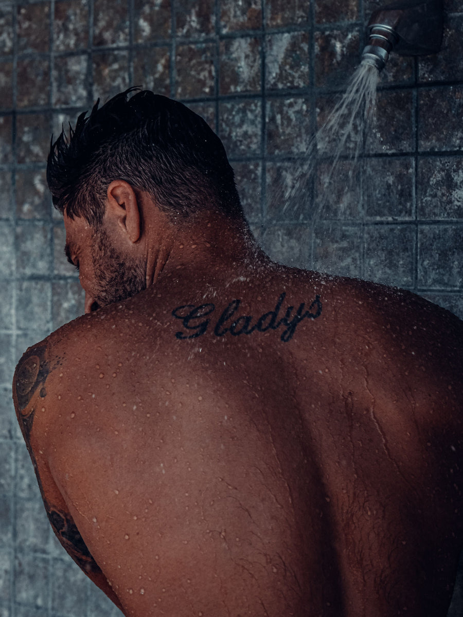 Man taking a shower as part of a daily body care routine